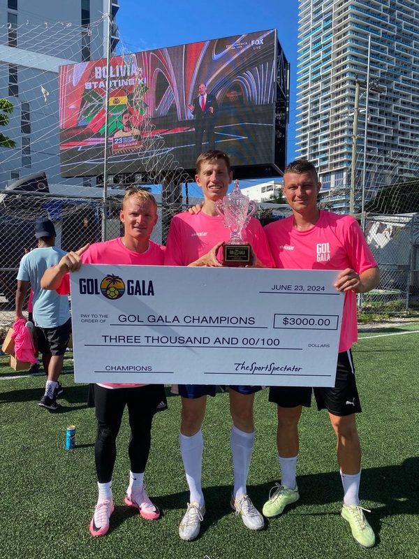 Anton Abyzov and teammates holding an oversized Gol Gala champions cheque dated June 23 2024.