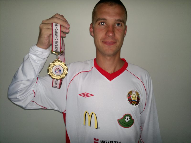 Anton Abyzov in the white Belarus national shirt holding a gold medal on a European Champions ribbon.